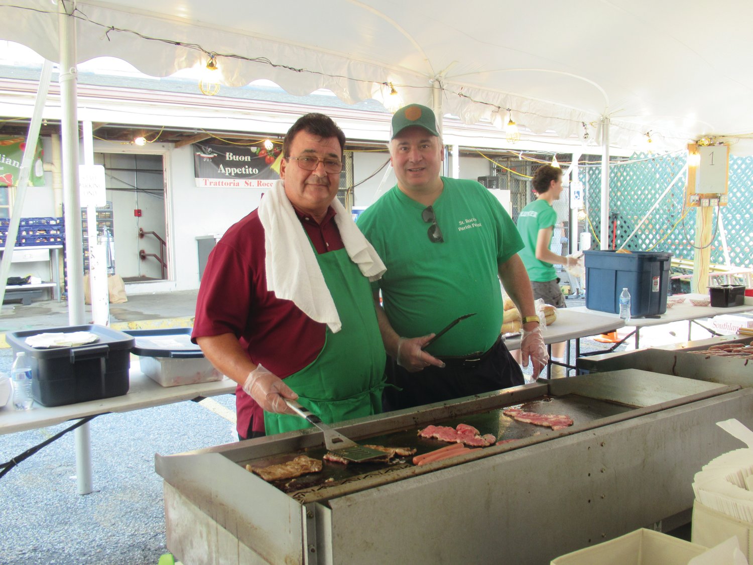 GRILL GUYS: Alex Palioottya (left) and Frank DiBiase were among those Holy Name Society members who cooked everything from steak sandwiches to sausage and peppers during the feast and festival.